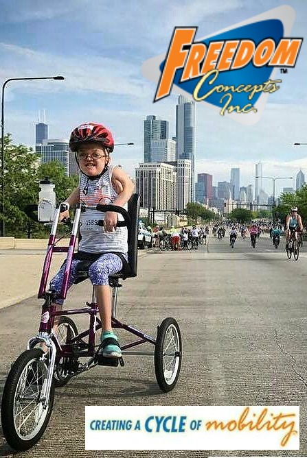 Young girl on customized Freedom Concepts trike in a "Ride the Drive" event in a metro area (skyscrapers in background).