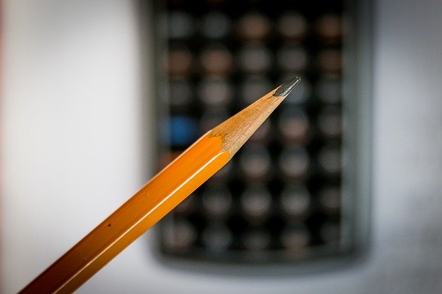 Pencil (tight shot); calculator in background, indicating "salary calculator."