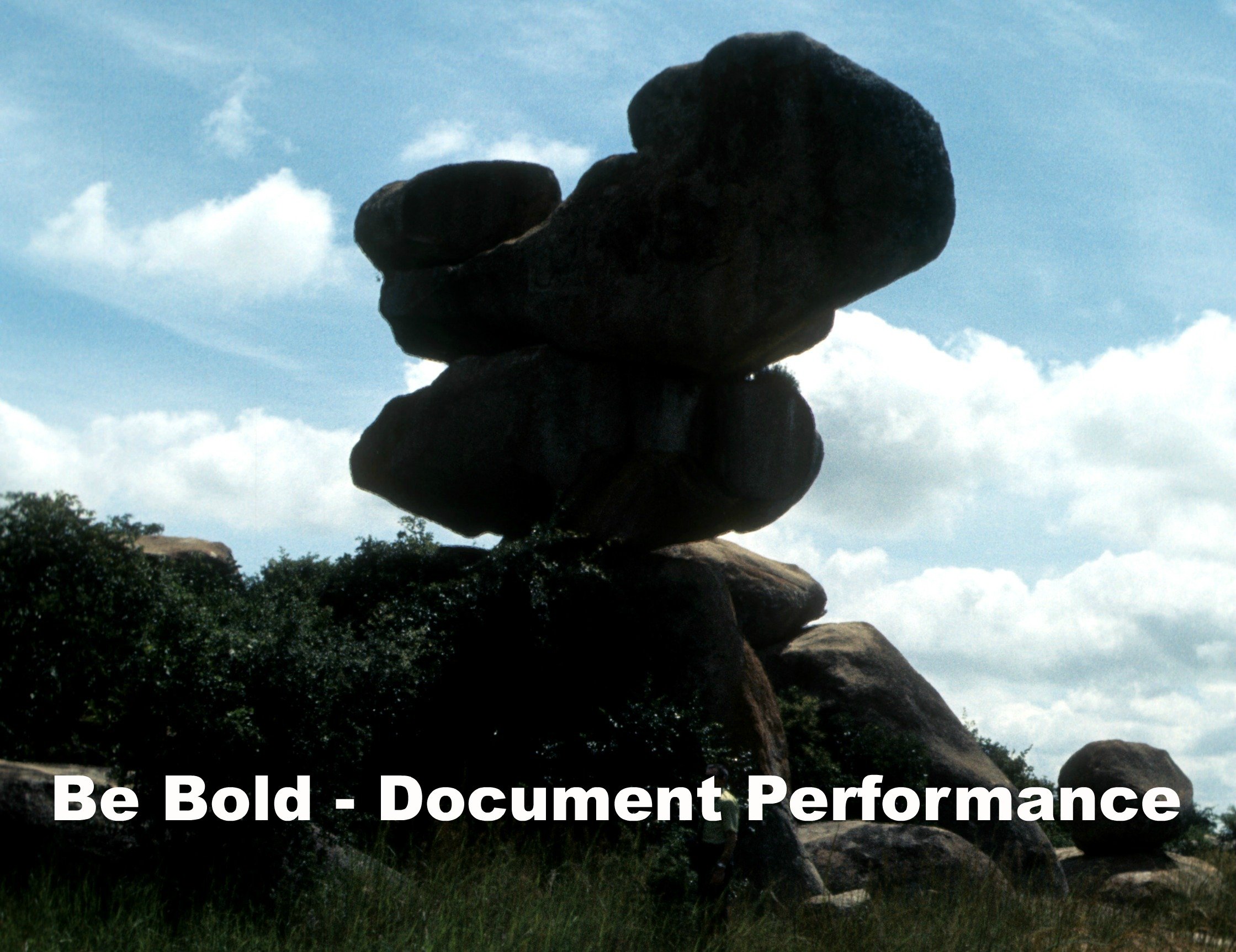 Teetering Rock Formation with Caption, "Be Bold -- Document Performance