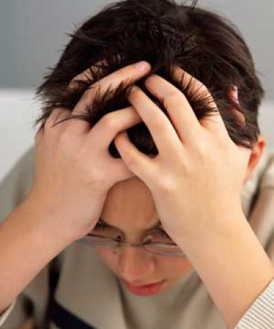 Color photo of young boy with hands in his hair, showing fvrustration.Design with this script: Success and Recognition Are Essential Ingredients for Self-confidence